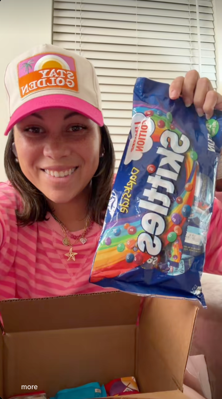 Customer holding a Skittles bag from her Galactic Snacks box in a TikTok video