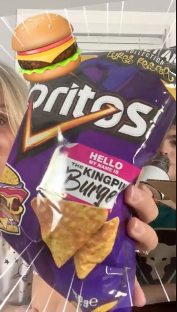 Customer holding Burger Doritos in a YouTube review