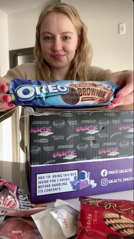 Customer holding Choco Brownie Oreo from a Galactic Snacks box in a TikTok video